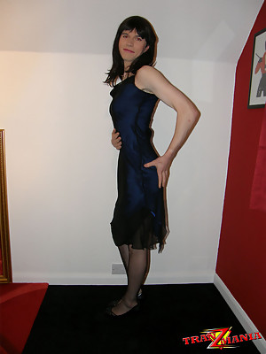 Crossdresser wearing a sultry blue dress & posing